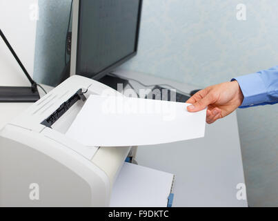 Businessman working with printer in the office Stock Photo