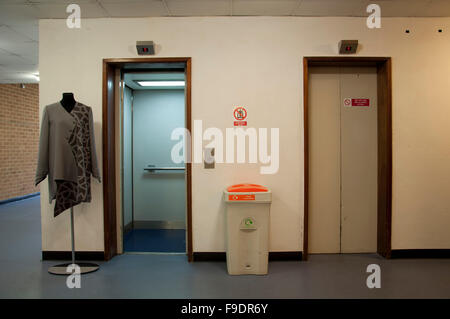 A hallway with two lifts (one open) Stock Photo