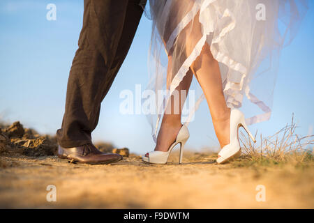 Bride and groom walk in summer nature Stock Photo