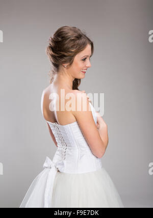 Portrait of beautiful bride posing isolated over gray background Stock Photo