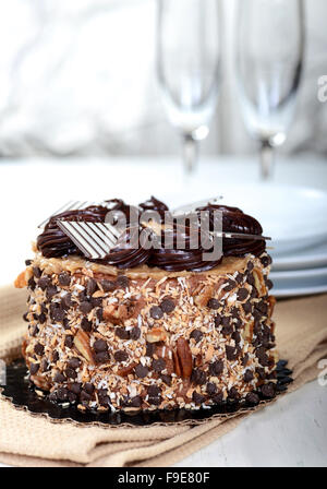 Whole German Chocolate Cake with plates and Champagne glasses Stock Photo