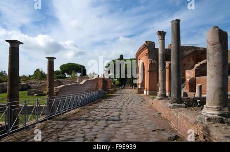 Roman road leading past the Theatre of Orchestra in the ancient Roman port of Ostia, near Rome, Italy, Europe Stock Photo