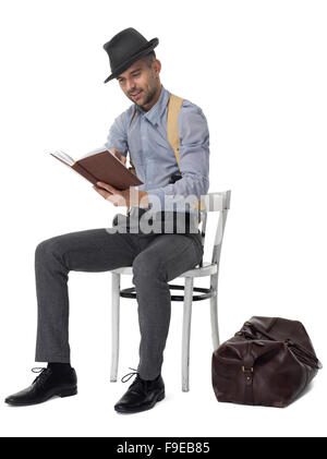 Businessman reading how to rob a bank portrait isolated on white background Stock Photo