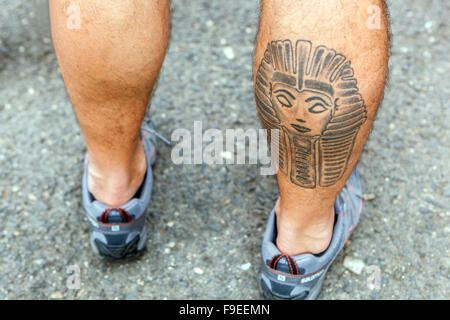 Tattooed male calf muscle Stock Photo - Alamy