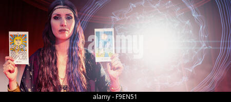 Composite image of portrait of fortune teller woman showing tarot cards Stock Photo