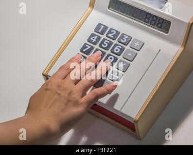 closeup oh hand with calculator on  desk background Stock Photo