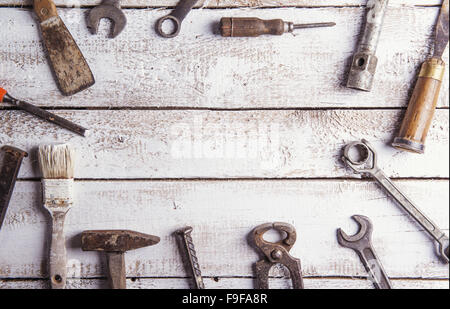 Desk of a carpenter with various tools. Studio shot on a wooden background. Stock Photo