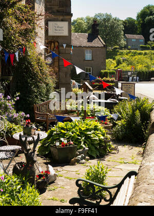 UK, England, Derbyshire, Hartington, Village Stores, bunting above outdoor café tables Stock Photo