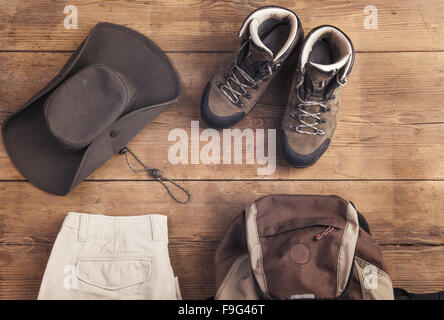 Equipment for hiking on a wooden floor background Stock Photo