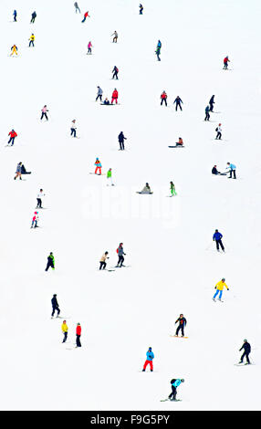 Lots of skiers and snowboarders on a slope at ski resort Stock Photo