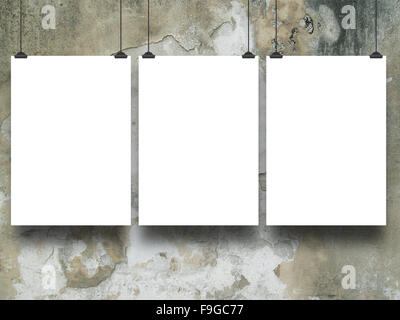 Close-up of three hanged paper sheets on beige moulded concrete wall background Stock Photo