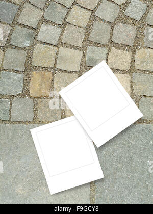 Two square instant photo frames on historical stone pavement background Stock Photo