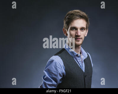 Stylish handsome young man posing. Studio shot on white background Stock Photo