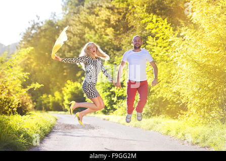 Attractive happy young couple having fun outside in a park Stock Photo