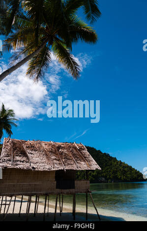 Lonely Nipa Hut on stilts at a Beautiful  Beach in front of the ocean Stock Photo