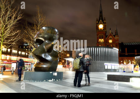 KING'S CROSS, LONDON, UK - 5 MARCH 2015 In front of King's Cross Station at night with Henry Moore sculpture and St. Pancras Stock Photo