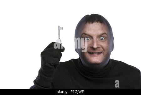 Thief in balaclava making funny faces, dressed in black. Studio shot on white background. Stock Photo