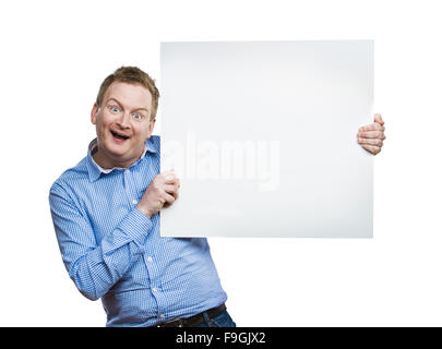 Young man making funny face, holding a blank sign board. Studio shot on white background. Stock Photo