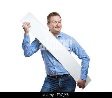 Young man making funny face, holding a blank sign board. Studio shot on white background. Stock Photo