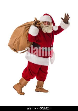 Santa Claus carrying big bag full of gifts, at home near Christmas Tree ...