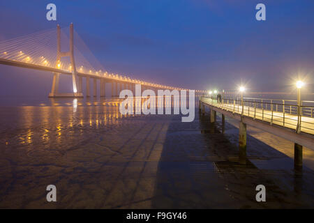 Foggy evening at Vasco  da Gama Bridge in Lisbon, Portugal. Stock Photo
