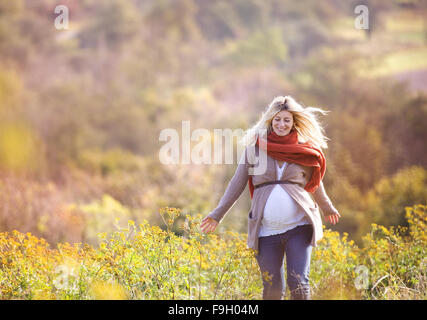 Portrait of beautiful pregnant woman in a field Stock Photo