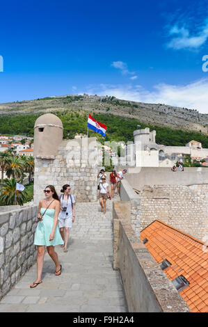 Tourists walking on the perimeter wall of the castle in the Old Town, Dubrovnik, Croatia. Stock Photo