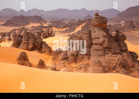 Sandstone and dunes, Jebel Acacus, LIbya, Mountains in Sahara Desert UNESCO World Heritage Site, The Awiss Stock Photo