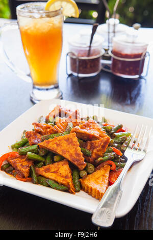 prik-king, a type of red curry,  with tofu and iced tea, Rice By Mama, Ventura, California Stock Photo
