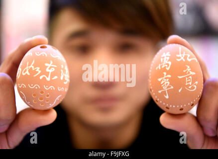 Bozhou, China's Anhui Province. 16th Dec, 2015. Chef He Ya, born in 1980s, shows egg carvings he made in Bozhou City, east China's Anhui Province, Dec. 16, 2015. Egg carving, a folk craft combining art forms of painting and carving, gets popular in recent years. © Liu Qinli/Xinhua/Alamy Live News Stock Photo