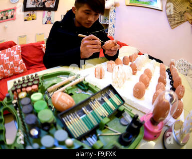 Bozhou, China's Anhui Province. 16th Dec, 2015. Chef He Ya, born in 1980s, makes egg carvings at home in Bozhou City, east China's Anhui Province, Dec. 16, 2015. Egg carving, a folk craft combining art forms of painting and carving, gets popular in recent years. © Liu Qinli/Xinhua/Alamy Live News Stock Photo