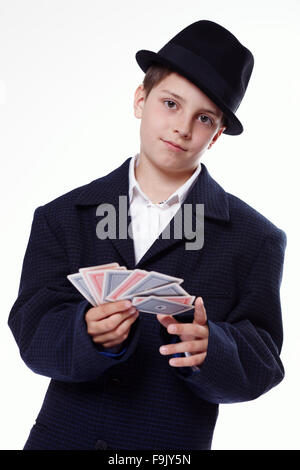 Portrait of a young boy holding playing cards