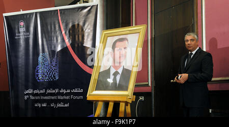 (151217) -- DAMASCUS, Dec. 17, 2015 (Xinhua) -- The portrait of Syrian President Bashar al-Assad is placed at the 8th Tourism Investment Market Forum in Damascus, Syria, Dec. 16, 2015. Over a hundred Syrian officials and researchers participated in the forum which opened here on Thursday. (Xinhua/Zhang Naijie) Stock Photo