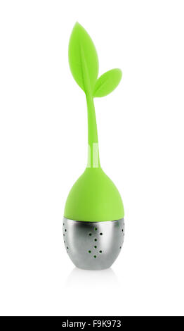 Tea infuser with metallic container and green rubber handle with leaves isolated on white background. Stock Photo