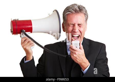 Elderly business man screaming loudly in a megaphone Stock Photo