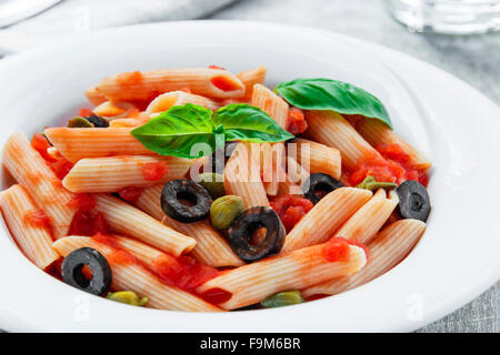 pasta with tomato sauce olives and capers Stock Photo