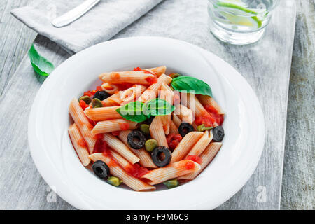 pasta with tomato sauce olives and capers Stock Photo