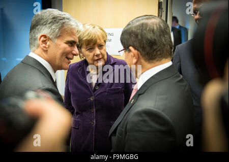 Brussels, Belgium. 17th Dec, 2015. HANDOUT - A handout picture made available by the German federal government on 17 December 2015 shows German Chancellor Angela Merkel (C), Austrian Chancellor Werner Faymann, and Turkish Prime Minister Ahmet Davutoglu speaking together at the start of a meeting on the situation of refugees in Europe in Brussels, Belgium, 17 December 2015. Photo: BUNDESREGIERUNG/GUIDO BERGMANN/dpa (ATTENTION EDITORS: free of charge - Editorial use only in connection with current reporting and with mandatory source credit: 'Bundesregierung/Bergmann/dpa')/dpa/Alamy Live News Stock Photo