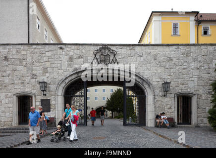 Pannonhalma Benedictine Abbey and visitors centre, Pannonhalma, Hungary. Stone gateway arch with ironwork motif above. Stock Photo