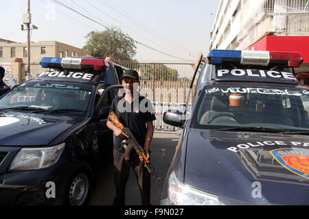 Police officials stand alert to avoid untoward incidents during protest demonstration of All Karachi Tajir Ittehad (AKTI) against the proposed curtailment in Rangers' anti-terror powers and limiting their authority to take action against facilitators of terrorism and crimes, outside Sindh Assembly building in Karachi on Thursday, December 17, 2015. Stock Photo