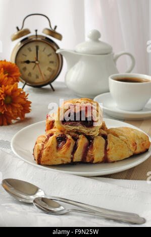 A piece of strudel with cherries with a morning cup of coffee Stock Photo