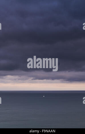 Alone sailing boat at sea in a storm Stock Photo