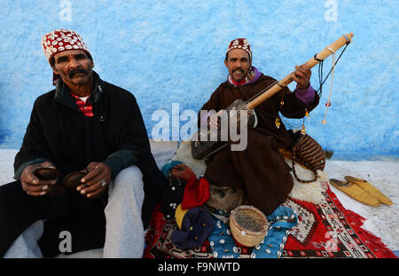 Gnawa musicians playing the Sintir and the Krakebs in the kasbah or Rabat. Stock Photo