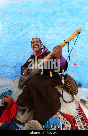 A Gnawa musician playing the Sintir in the kasbah or Rabat. Stock Photo