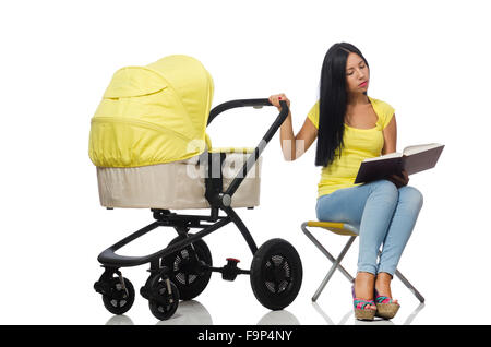 Young mom with baby and pram reading book Stock Photo