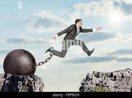 Image of young businessman jumping over gap Stock Photo