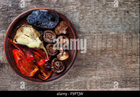 mix of grilled vegetables on clay plate view from above Stock Photo