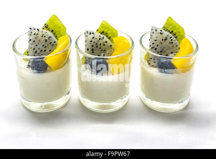 yogurt penna cotta with various fruits topping in glassware on soft tone background Stock Photo