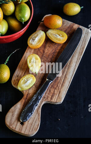 Detail of Kumquat on wooden board Stock Photo