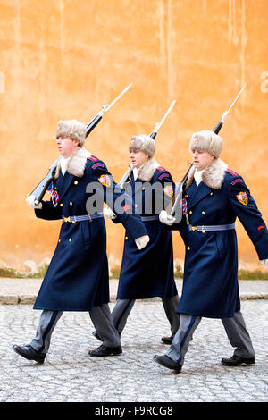 Three guards marching past wall whilst changing at Prague Castle, Czech Republic.